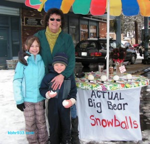 Local Linda Meekins, here with Daisha and Mason, sold her authentic Big Bear snowballs during the Village expo.