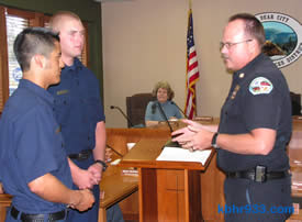 Bear City Fire's new PCFs Tom Morgan and Justin Ploense with Chief Willis (as CSD Director Barbara Beck looks on).