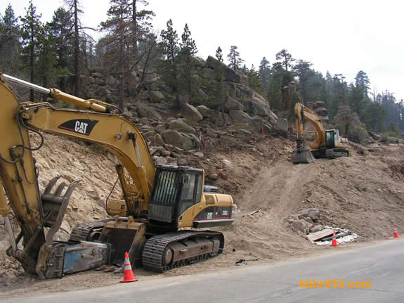 Some rocks along the hillside (here, just south of the dam on Highway 18) will be blasted. The first blast took place on May 11.