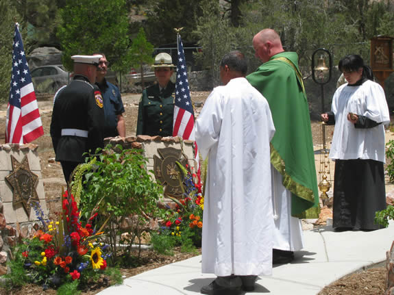 The June 28 ceremony concluded with a blessing by Father Mike (in green). The memorial walkway is at St Joseph's, which is on the North Shore just east of Stanfield Cutoff.