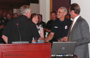 BBL Fire's Lance Swafford gets a congratulatory handshake from new Chief Rod Ballard, while wife Eileen, Assistant Chief Mark Mills and Mayor Herrick look on.