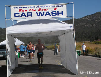 The Big Bear Lake Antique Car Club's "car wash" was a welcome water spritzing for runners, at the marathon's turn-around on Sandalwood.