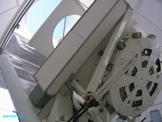 Because the telescope is so big relative to the size of the observatory's dome, it is difficult to pull back far enough to get a complete photo of the apparatus. The 1.6 meter mirror is housed in the round component to the right. The telescope turns on an axis parallel to the axis of the earth, and also changes position seasonally.