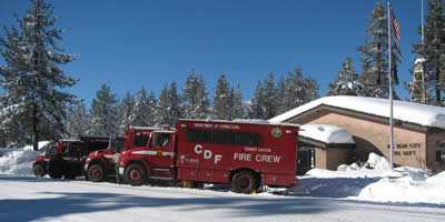 Ten CalFire crews are now in the Big Bear Valley, assisting in removing hazardous trees that were blocking roadways and plows, shoveling snow from roofs of mobile homes, and clearing fire hydrants.